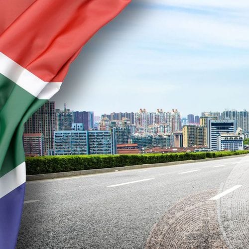 South Africa's flag unveiling a view of a South African city